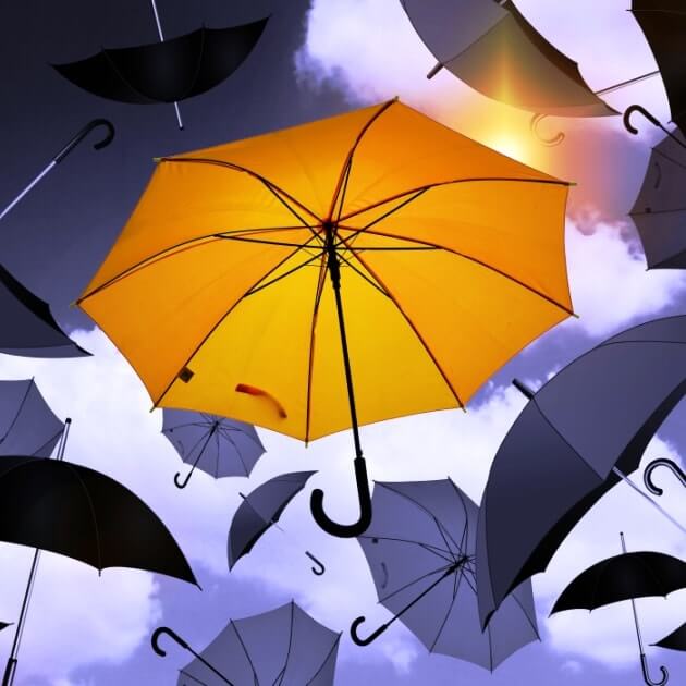 unique yellow umbrella among black ones. Choosing your business consultant. Blazetrue article